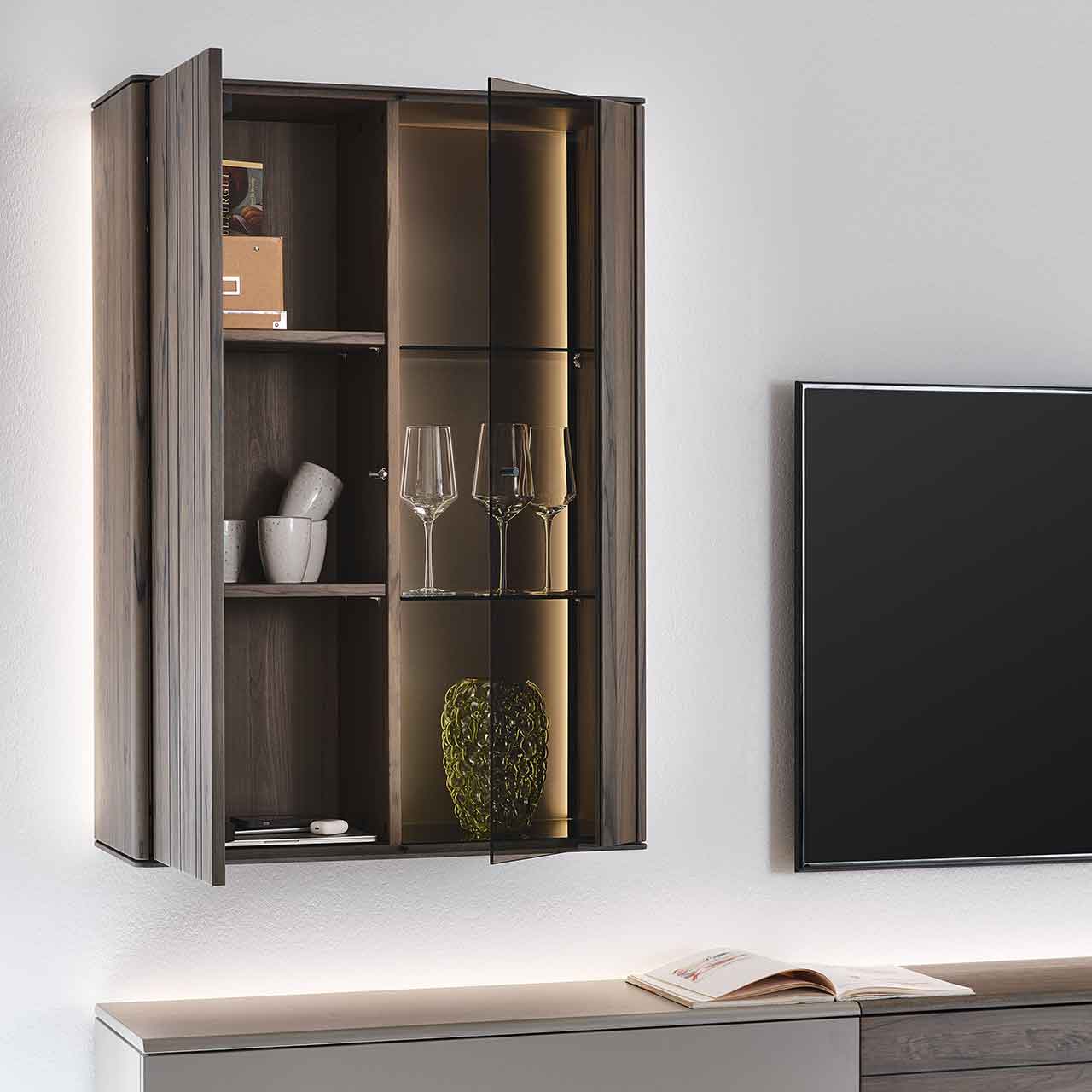 Moderne Hängevitrine aus massiver dunkelbrauner Altholzbuche Uyaa mit geöffneter Holztür links, zwei sichtbaren Holzeinlegeböden sowie geöffneter Glastür rechts mit zwei Glasböden und seitlicher Beleuchtung.